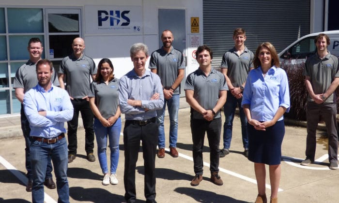 PHS team members standing in front of company headquarters